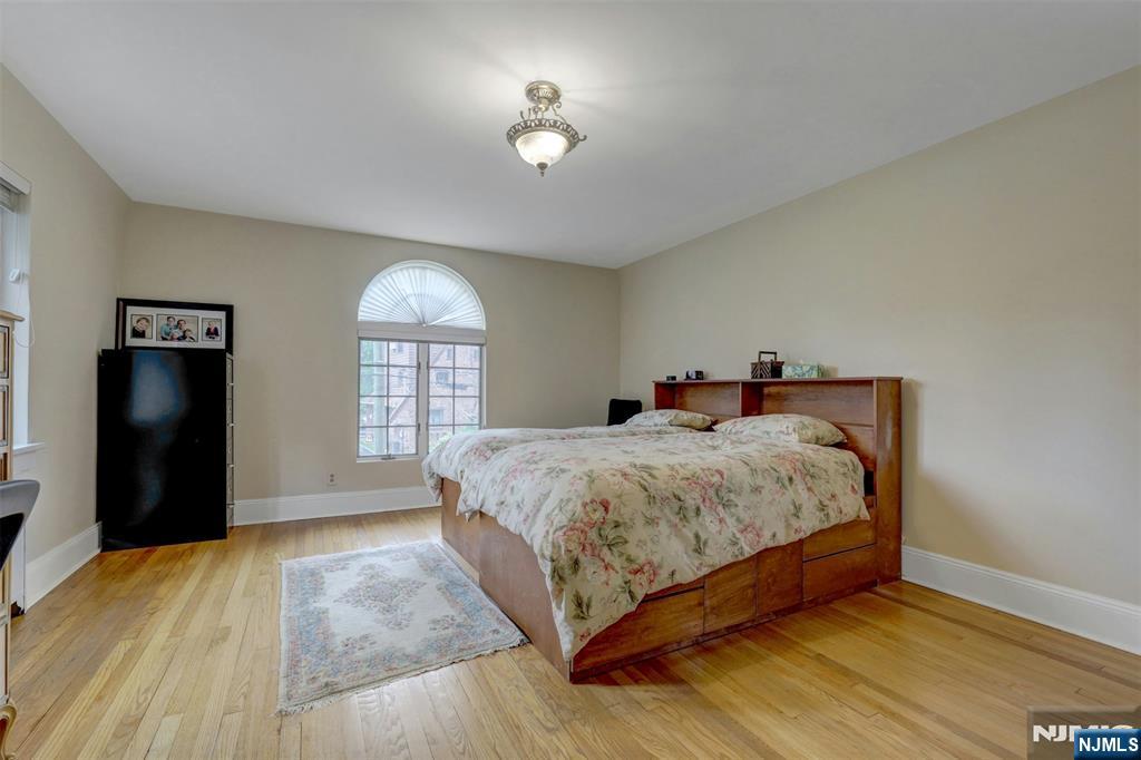 548 Standish Road Teaneck, NJ 07666 - Photo 17 of 28 a spacious bedroom with a bed and a window