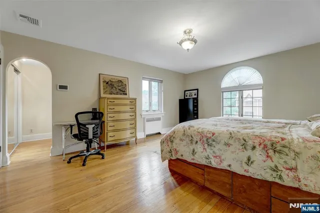 a bedroom with a bed and a chandelier
