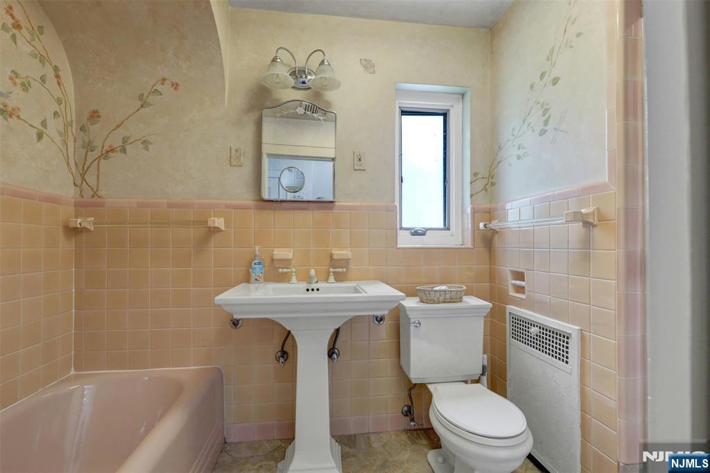 548 Standish Road Teaneck, NJ 07666 - Photo 19 of 28 a bathroom with a sink a toilet and shower