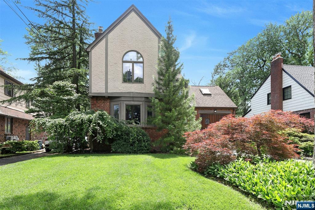 548 Standish Road Teaneck, NJ 07666 - Photo 2 of 28 a front view of a house with a garden