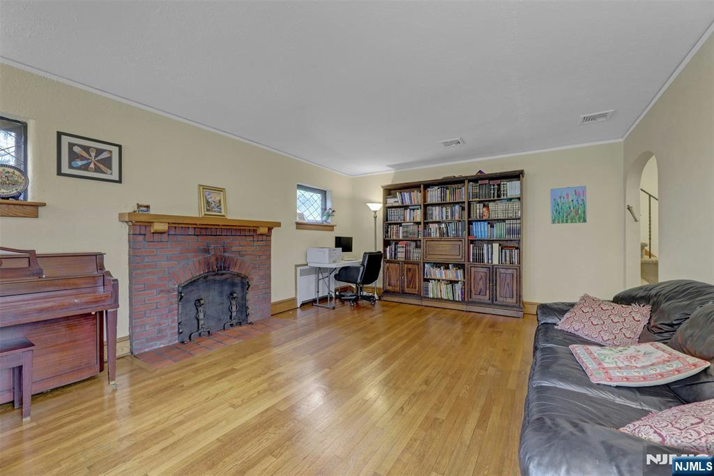 548 Standish Road Teaneck, NJ 07666 - Photo 6 of 28 a living room with furniture and a fireplace
