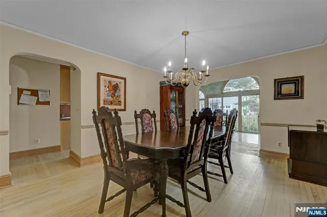 a view of a dining room with furniture and chandelier