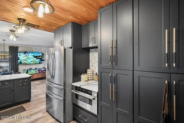 a kitchen with stainless steel appliances a refrigerator and a stove