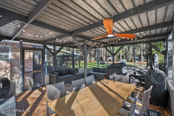 a backyard of a house with barbeque oven table and chairs