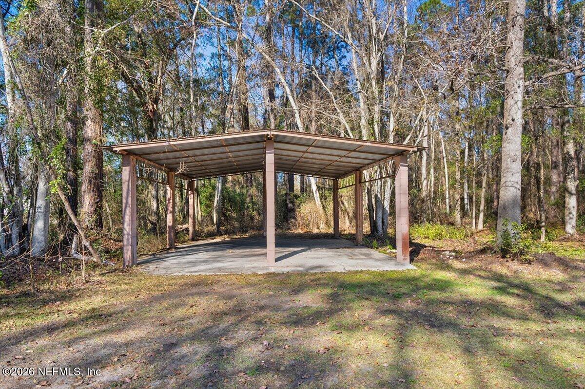 1917 Blair Road Jacksonville, FL 32221 - Photo 21 of 30 a backyard of a house with barbeque oven table and chairs