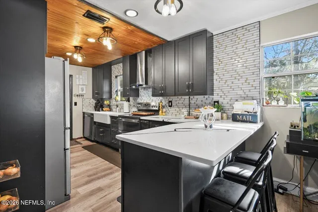 a kitchen with a sink a stove and chairs