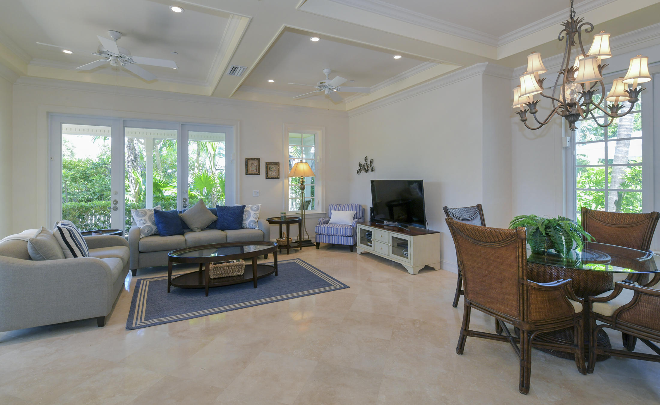 58 Sunset Key Drive Key West, FL 33040 - Photo 12 of 35 a living room with furniture a flat screen tv and a large window