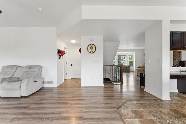 a view of entryway and hall with wooden floor