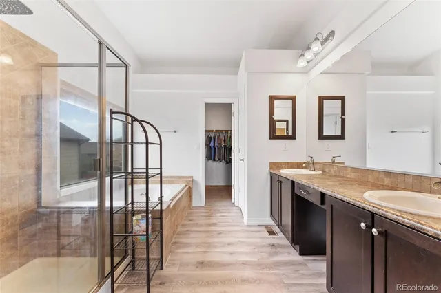 a view of a bathroom with dual sinks