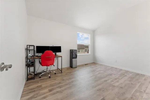 a view of a room with a wooden floor and a sink
