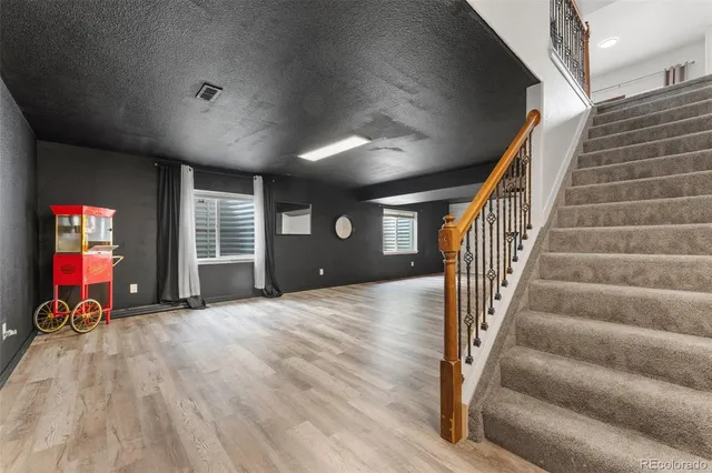 a view of entryway with wooden floor and windows