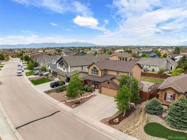 an aerial view of a house with a garden