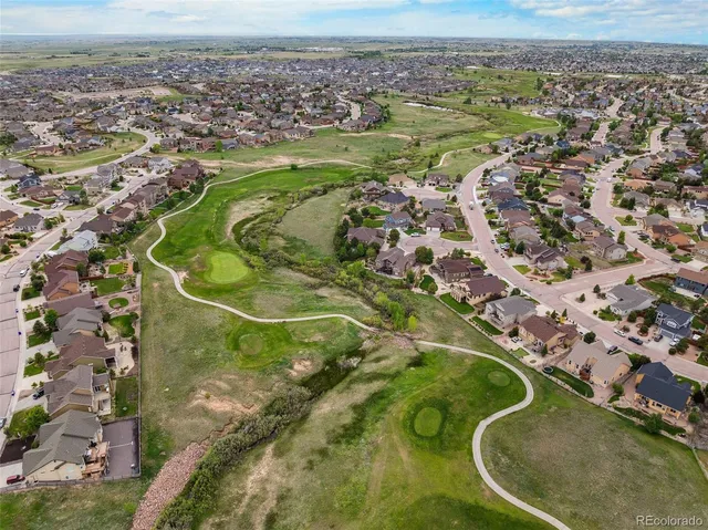 an aerial view of a residential houses with outdoor space