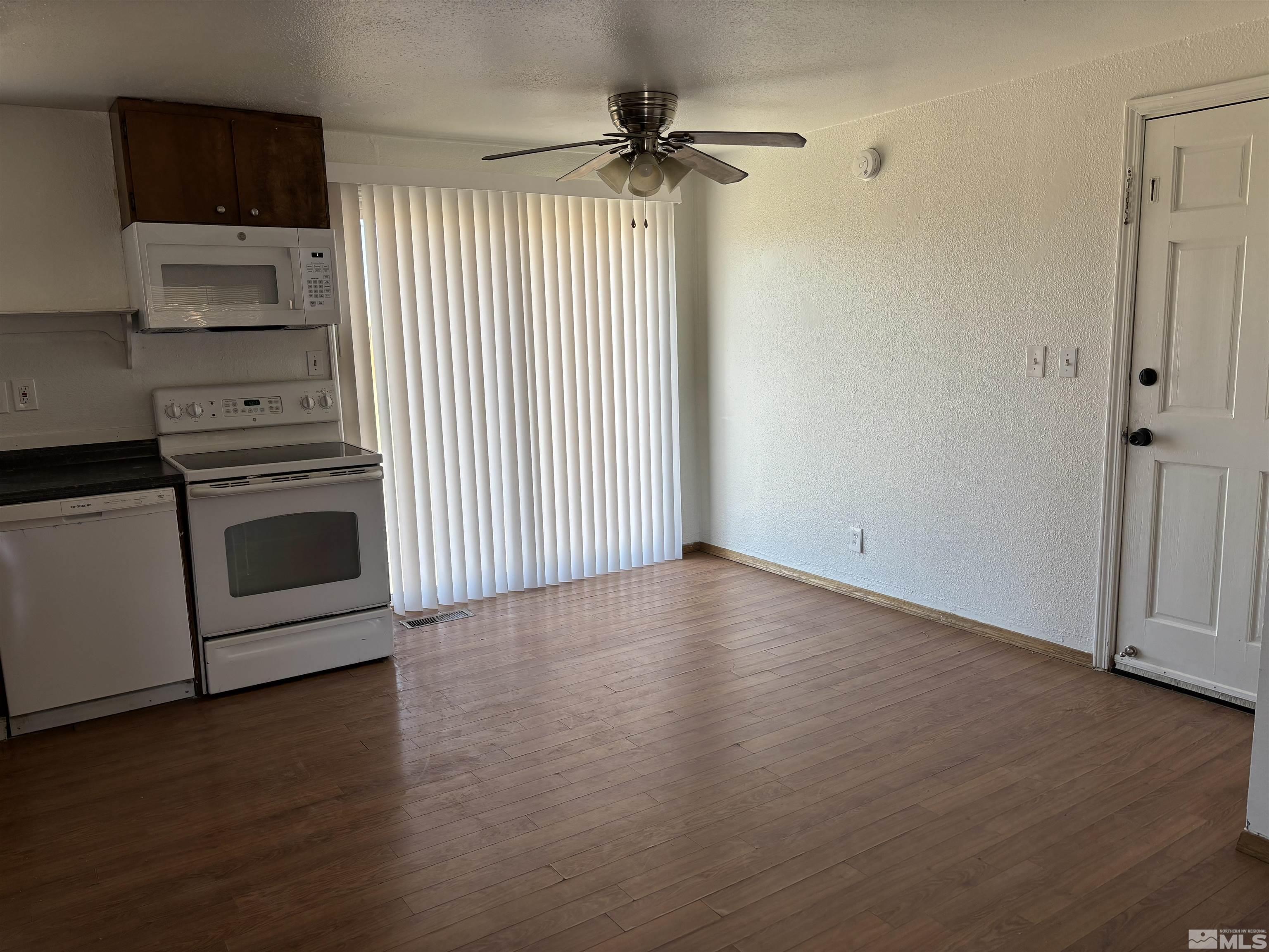 9405 Fremont Way Reno, NV 89506 - Photo 3 of 14 a view of a kitchen with a stove wooden floor and a cabinet