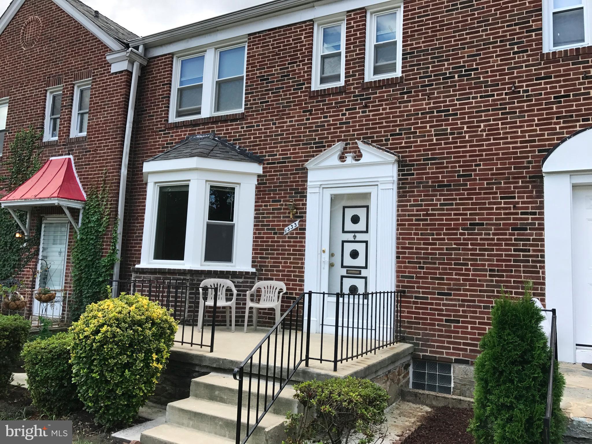 1533 Northgate Road Baltimore, MD 21218 - Photo 1 of 18 a front view of a house with a garden
