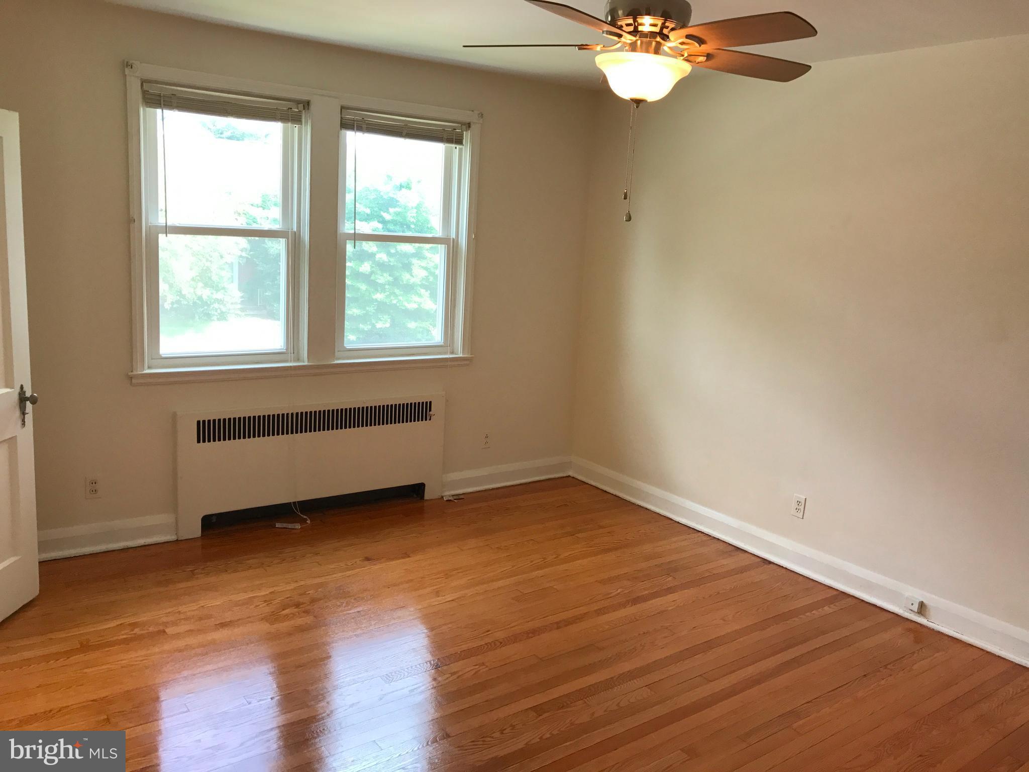 1533 Northgate Road Baltimore, MD 21218 - Photo 11 of 18 a view of a room with wooden floor and a window