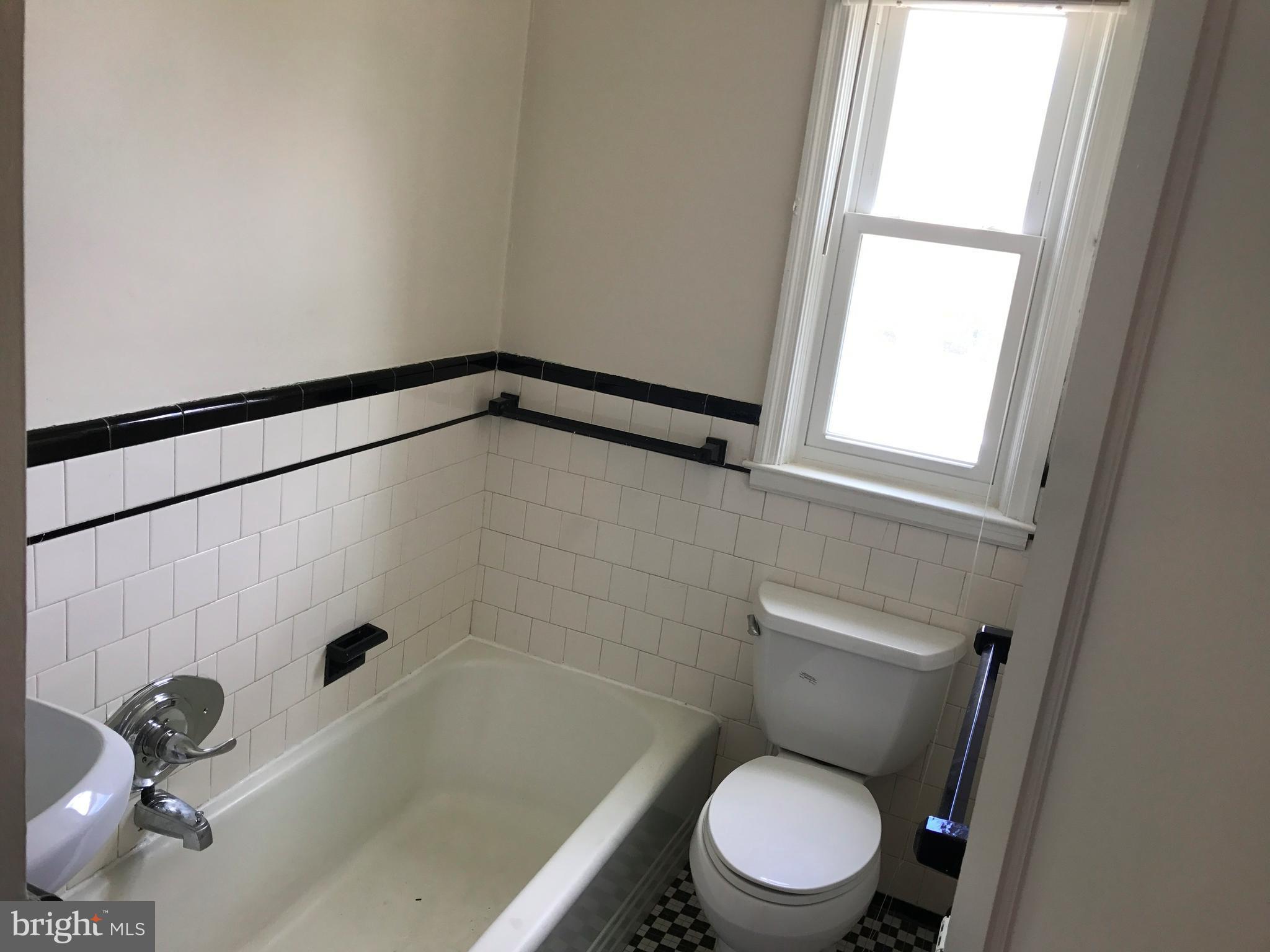 1533 Northgate Road Baltimore, MD 21218 - Photo 12 of 18 a white toilet sitting next to a bath tub