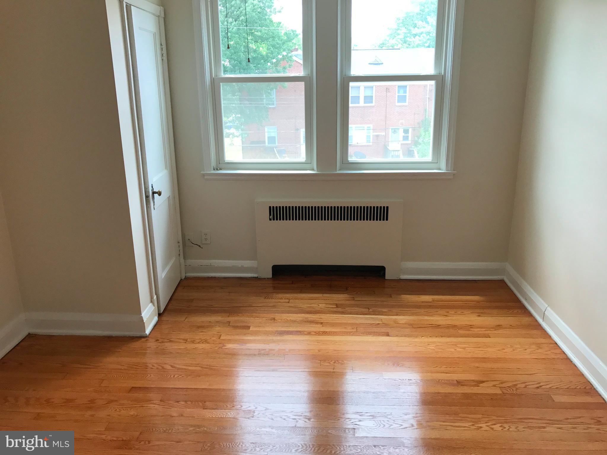 1533 Northgate Road Baltimore, MD 21218 - Photo 13 of 18 an empty room with wooden floor and windows