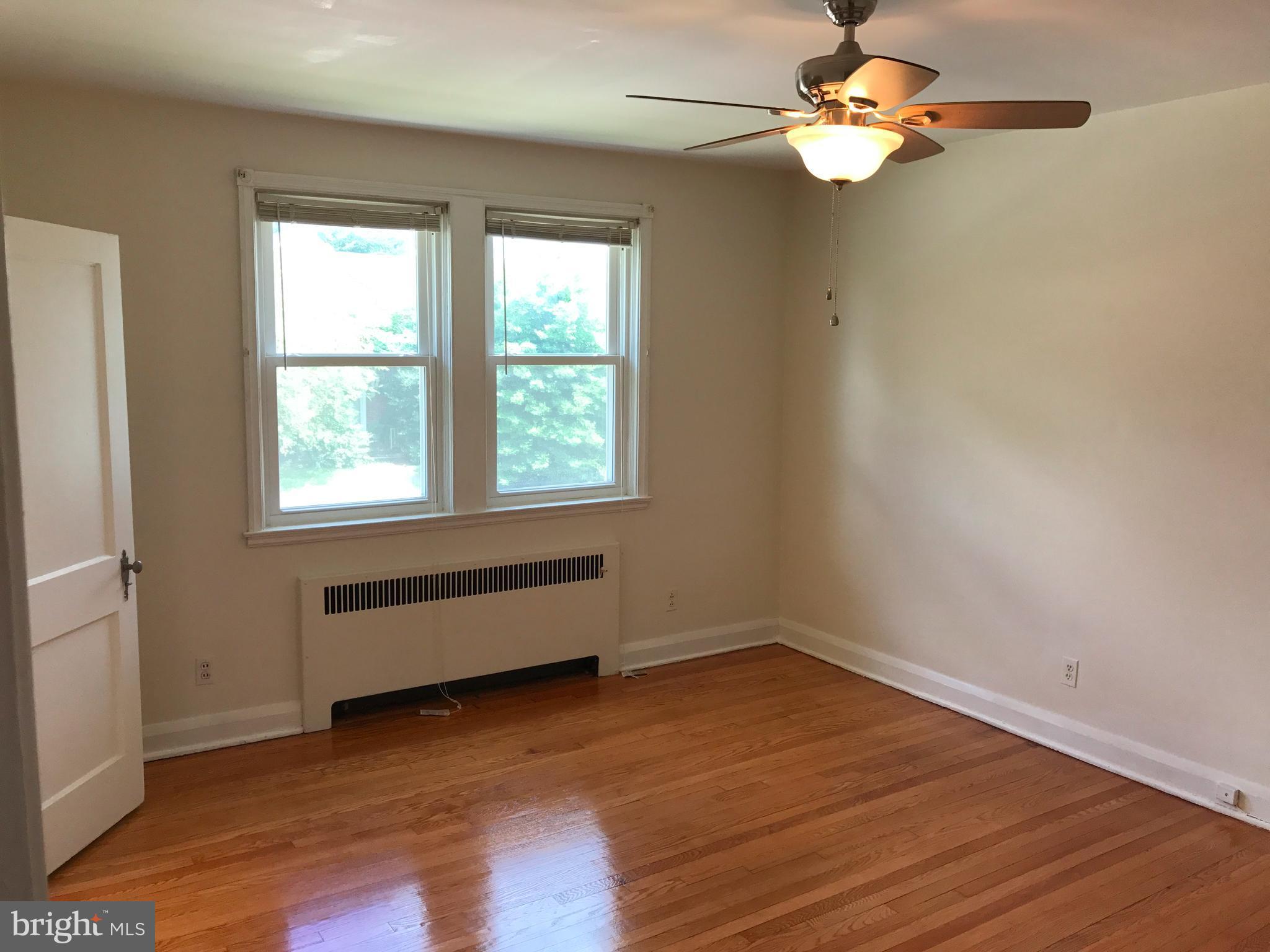 1533 Northgate Road Baltimore, MD 21218 - Photo 14 of 18 an empty room with wooden floor fan and windows