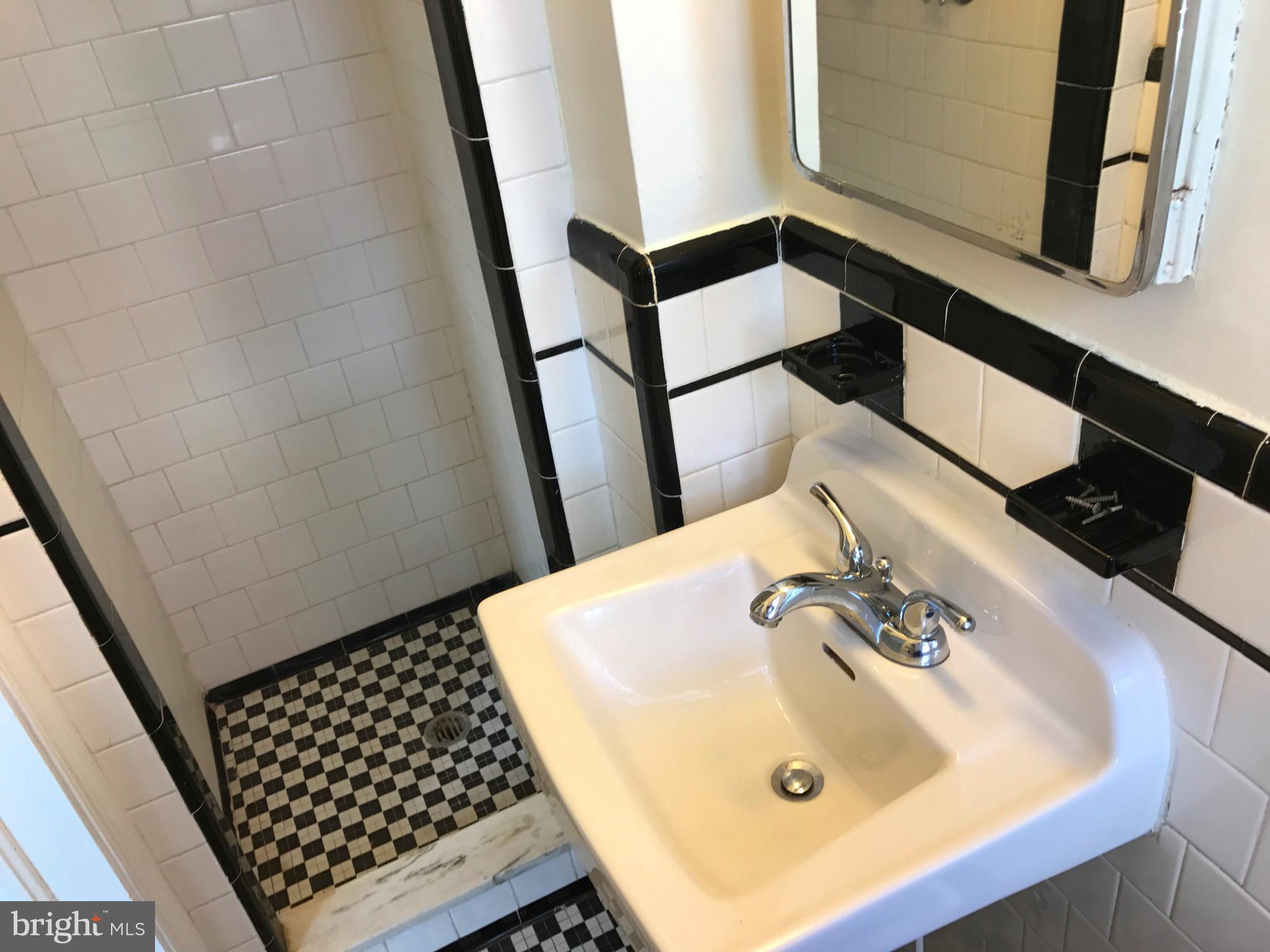 1533 Northgate Road Baltimore, MD 21218 - Photo 16 of 18 a bathroom with a sink and a mirror