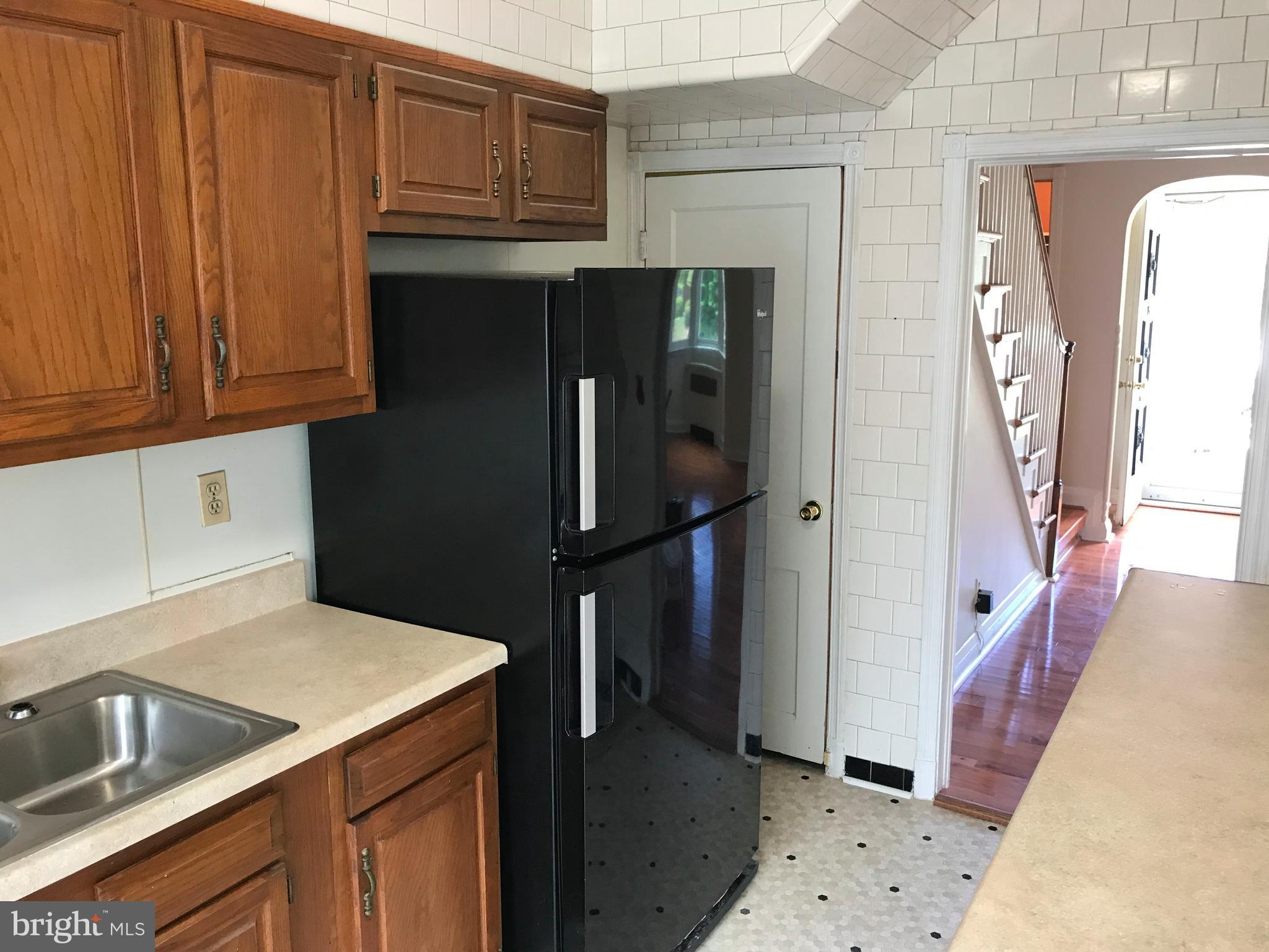 1533 Northgate Road Baltimore, MD 21218 - Photo 4 of 18 a kitchen with a refrigerator and cabinets