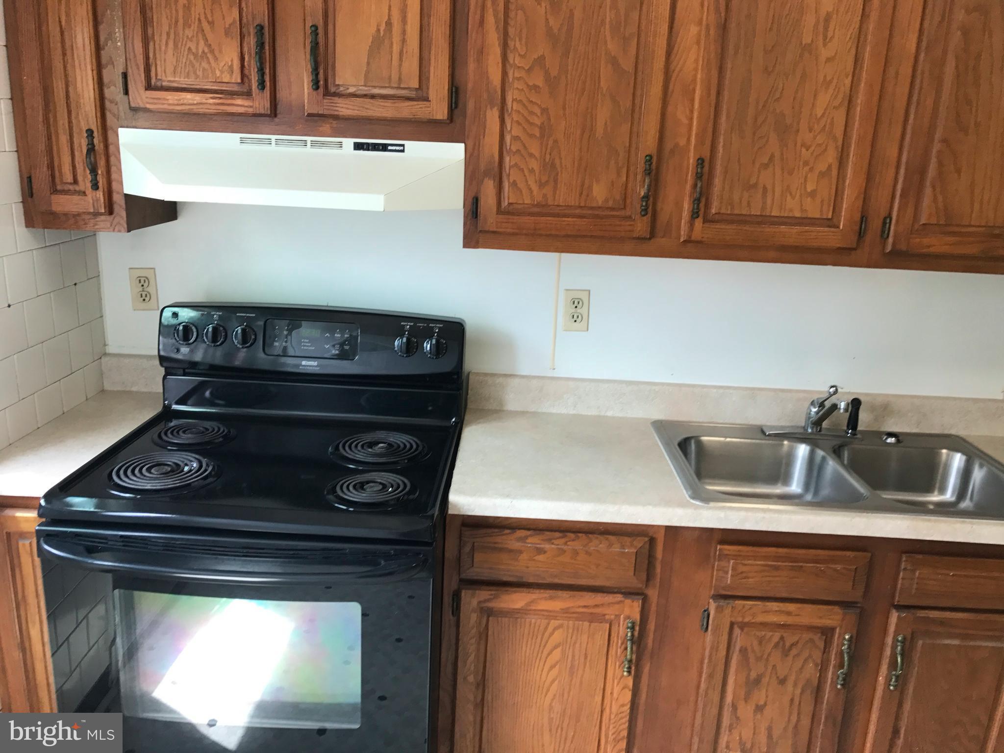 1533 Northgate Road Baltimore, MD 21218 - Photo 5 of 18 a kitchen with a stove and cabinets