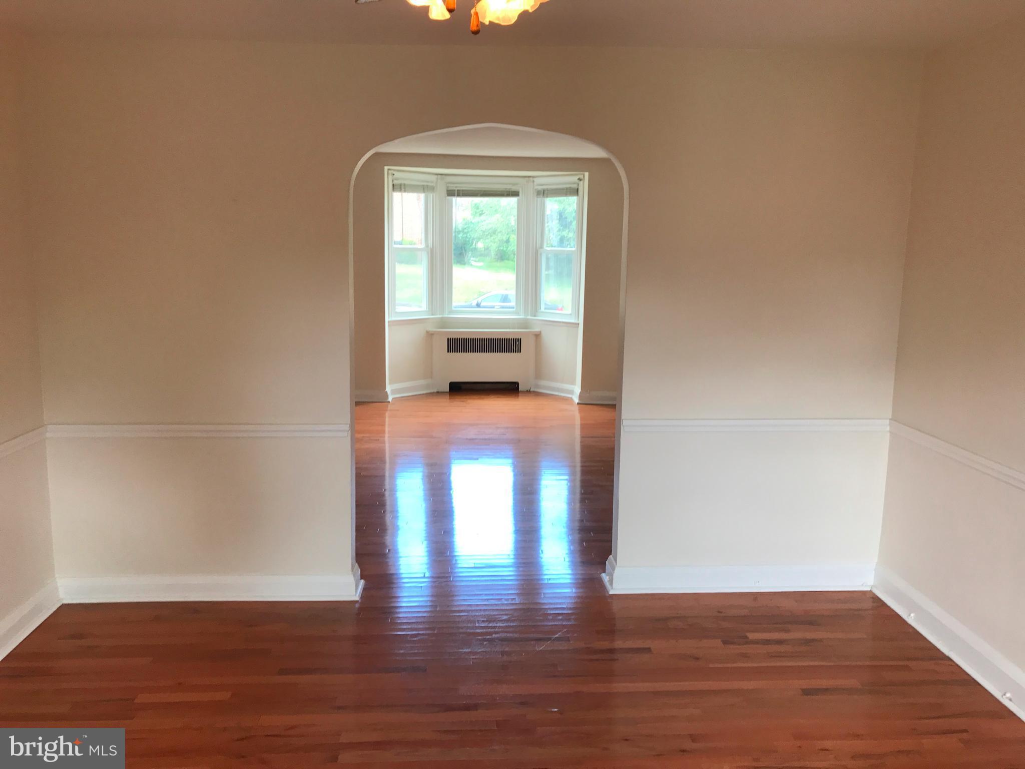 1533 Northgate Road Baltimore, MD 21218 - Photo 7 of 18 a view of a room with wooden floor and a window