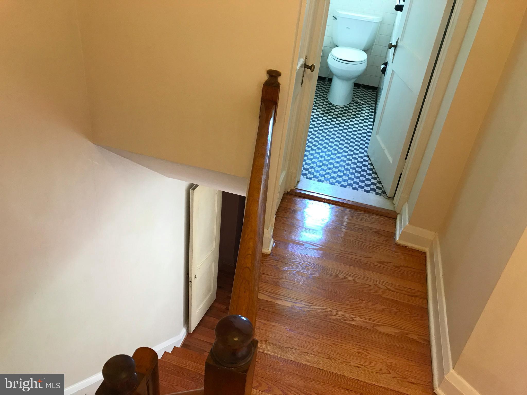 1533 Northgate Road Baltimore, MD 21218 - Photo 9 of 18 a view of a hallway with wooden floor and a bathroom