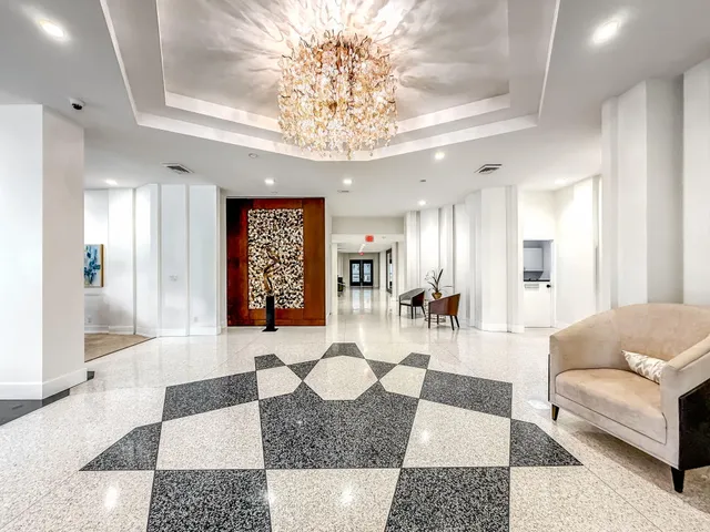 a view of a livingroom with furniture and a flat screen tv