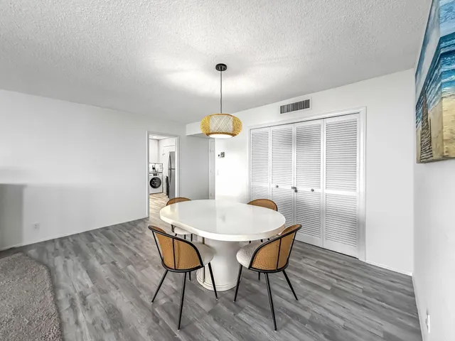 a kitchen with a stove a refrigerator and a microwave