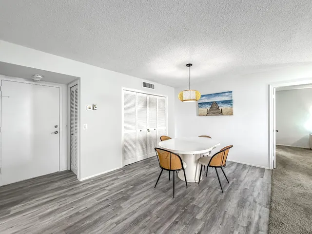 a room with stainless steel appliances granite countertop a refrigerator and a sink