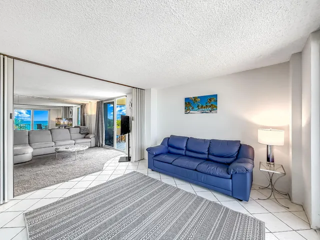 a view of a chairs and table in patio with a lake view