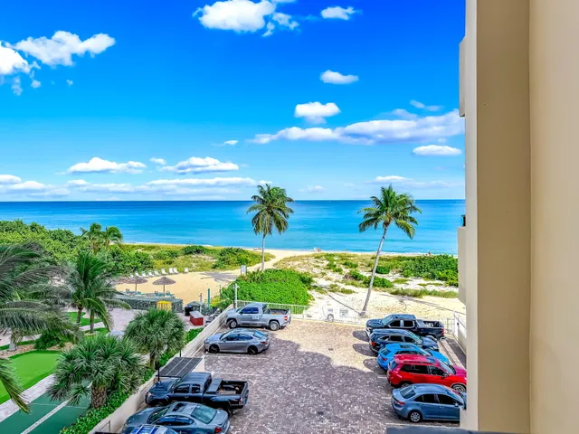 a view of a room with gym equipment and large windows