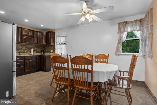 a view of a dining room with furniture and a chandelier