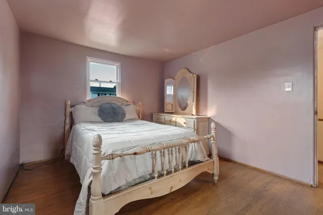 a bedroom with a bed and mirror