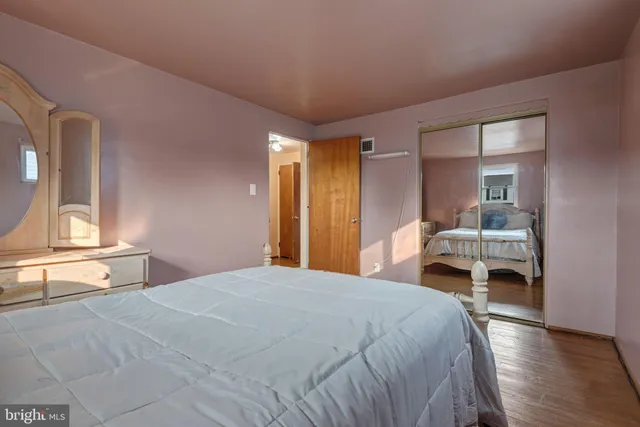 a bedroom with a bed and a large window