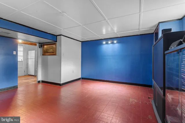 a view of an empty room with furniture and a kitchen