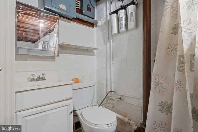 a view of a storage & utility room with refrigerator