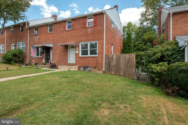 a front view of house with yard and outdoor seating