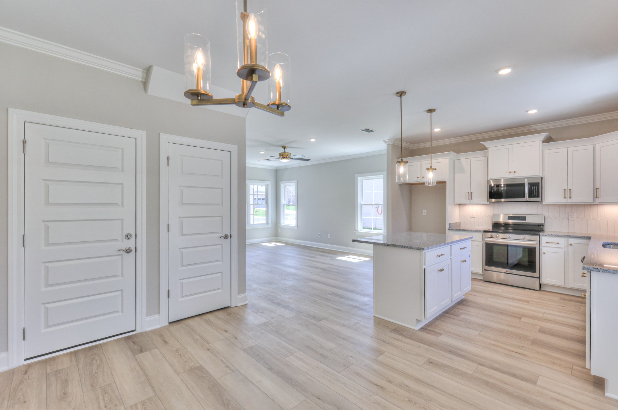437 Ruby Oaks Lane Murfreesboro, TN 37128 - Photo 15 of 38 a large kitchen with cabinets wooden floor and stainless steel appliances