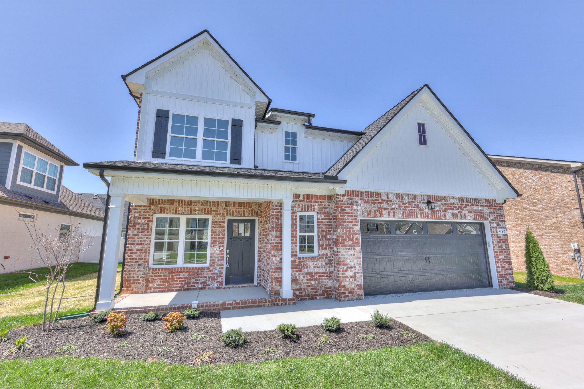 437 Ruby Oaks Lane Murfreesboro, TN 37128 - Photo 2 of 38 a front view of a house with a yard and garage