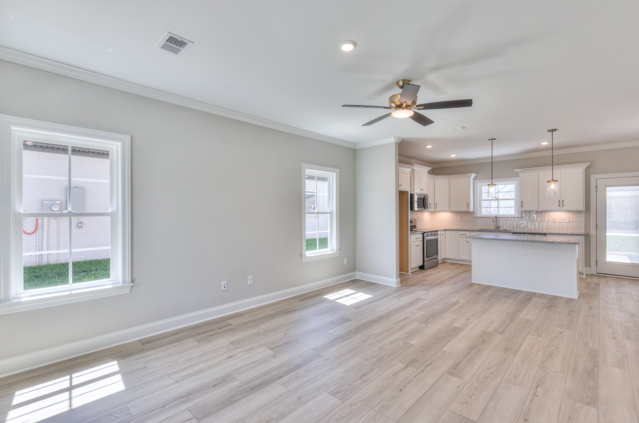 437 Ruby Oaks Lane Murfreesboro, TN 37128 - Photo 6 of 38 a view of kitchen with refrigerator microwave and wooden floor
