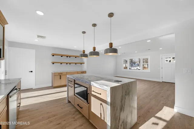 a kitchen that has a stove and a wooden floor