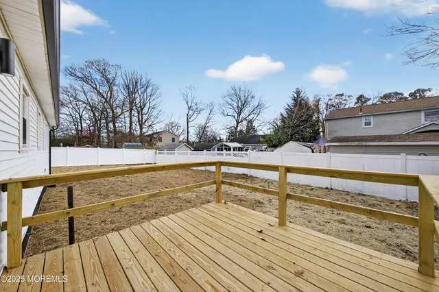 a view of a rooftop deck with couch and chairs
