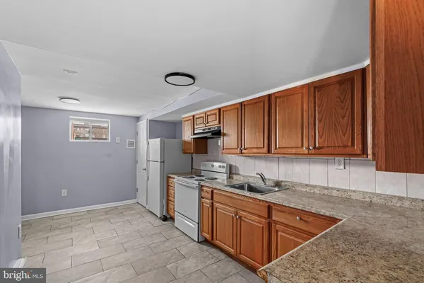 a kitchen with stainless steel appliances granite countertop a refrigerator sink and cabinets