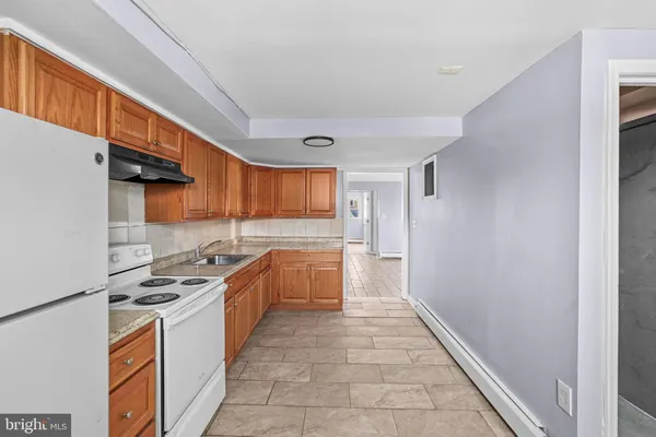 a kitchen with stainless steel appliances granite countertop a stove and a refrigerator