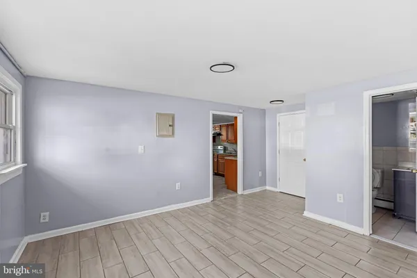 an empty room with closet and windows