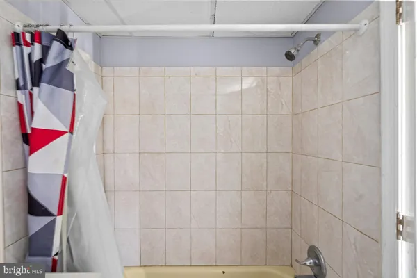 a bathroom with a bathtub and shower