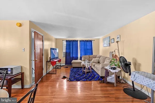 a living room with furniture or couch and a wooden floor