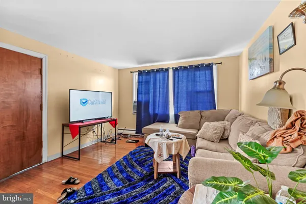 a living room with furniture a rug and a wooden floor